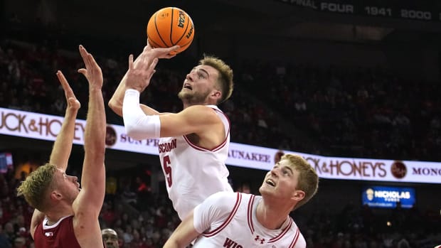 Wisconsin forward Tyler Wahl scores during the second half as Nebraska's Rienk Mast defends.